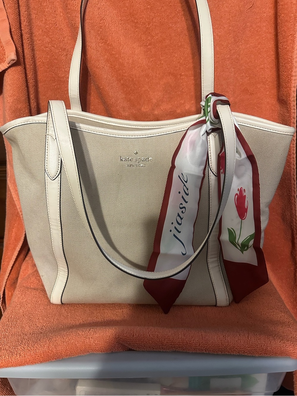 kate spade cream canvas tote with red-accented scarf